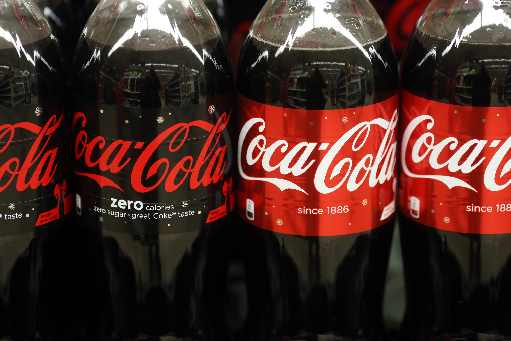 Bottles of Coca-Cola Zero sugar free soft drink, left, and regular Coca-Cola soft drink.