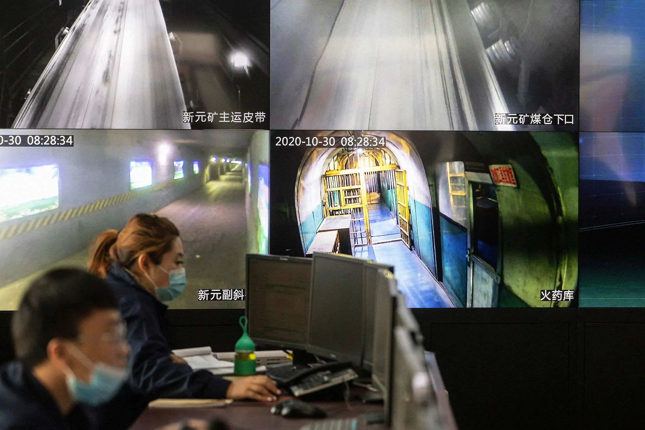 Employees work&nbsp;near a&nbsp;huge&nbsp;monitor&nbsp;in&nbsp;the central control room at the Xinyuan Coal Mine in Jinzhong, China.