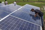 An employee inspects solar panels, part of a solar power microgrid, in the village of Dharnai in Jehanabad, Bihar, India, on Thursday, July 9, 2015. While Prime Minister Narendra Modi's ambition has led billionaires such as Foxconn Technology Group's Terry Gou to pledge investment, the question remains whether the 750 million Indians living on less than $2 per day can afford or will embrace green energy.
