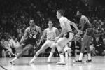 Boston's Sam Jones, left, drives past the Lakers' Jerry West (44) and drives along the baseline towards the basket in the teams' NBA playoff game in Los Angeles on May 2, 1968. At right are Darrall Imhoff of Lakers, who blocked the shot, and Celtics' Bill Russell. Basketball Hall of Famer Jones, the skilled scorer whose 10 NBA titles is second only to teammate Bill Russell, died on Thursday, Dec. 30, 2021, the team said. He was 88. (AP Photo/HF, File)