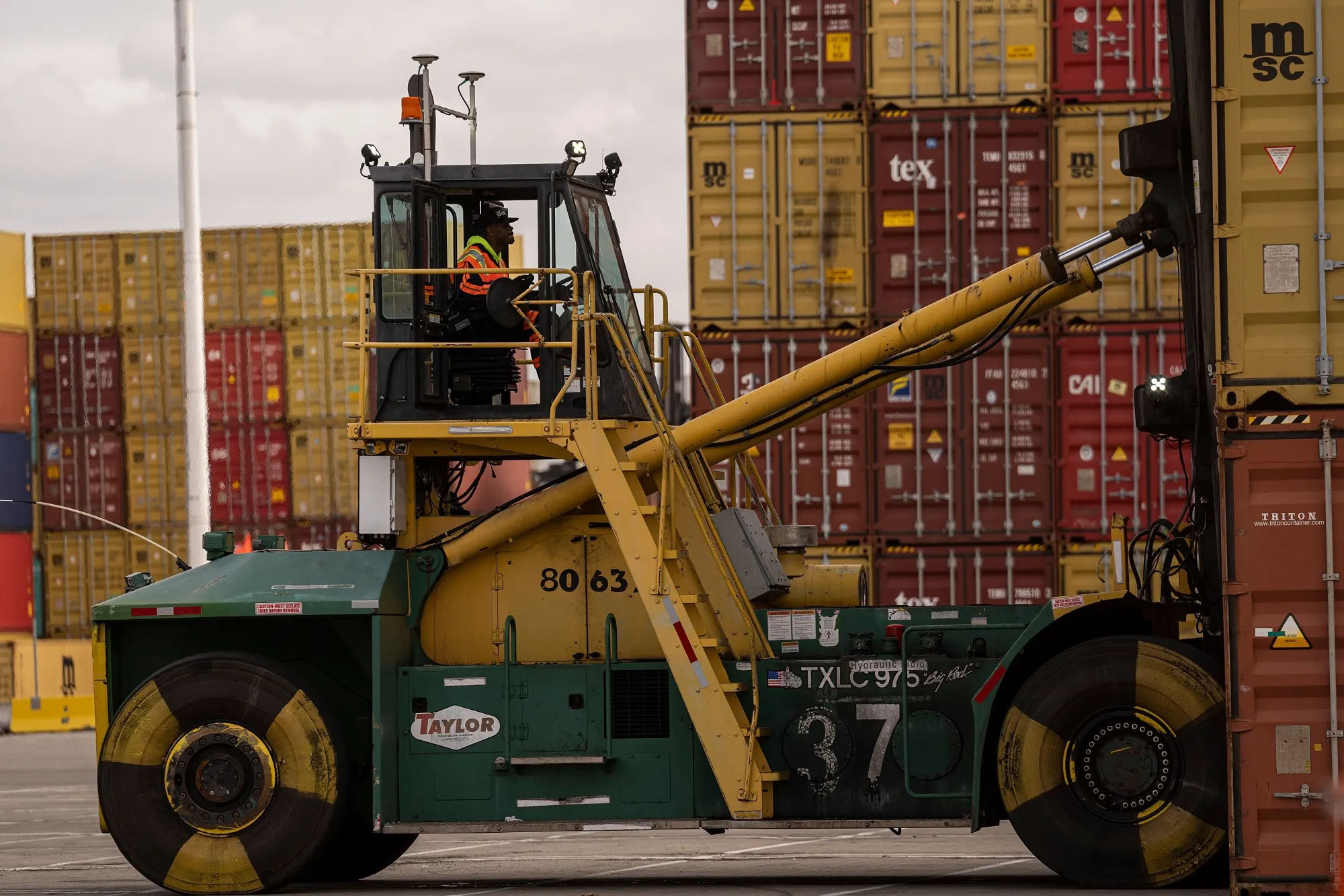 A worker operates a forklift to move shipping containers at the Port of Oakland in Oakland, on Oct. 26, 2021.&nbsp;