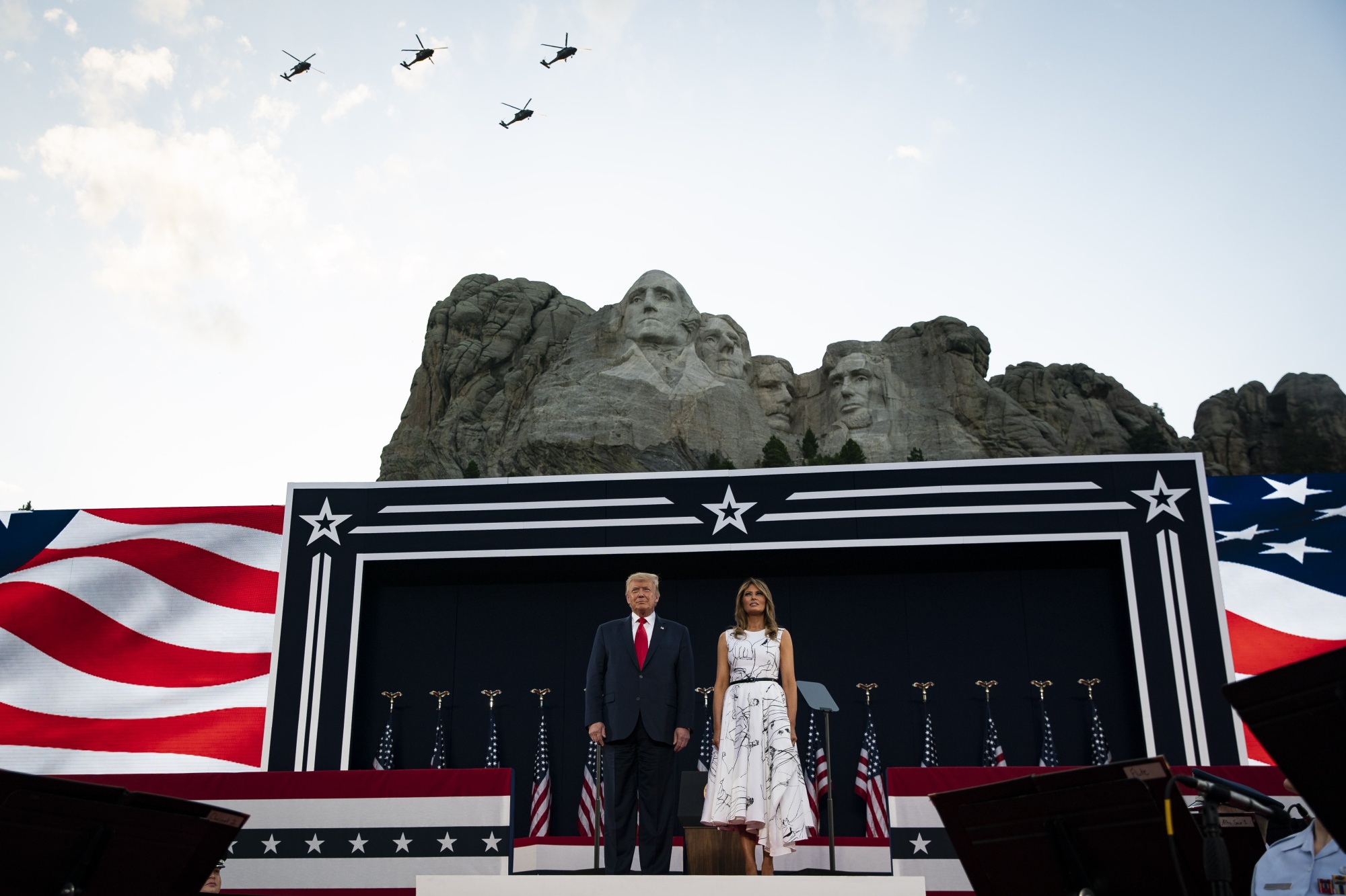 U.S. President Donald Trump and First Lady Melania Trump watch as South Dakota Army National Guard Sikorsky UH-60 Black Hawk helicopters fly over during an event at Mount Rushmore National Memorial in Keystone, U.S., July 3.&nbsp;
