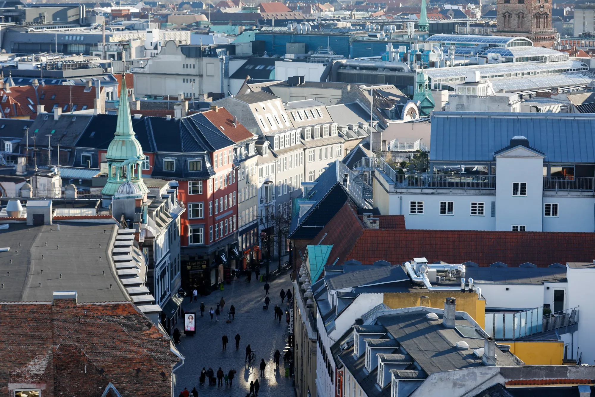 Shoppers walk through the Kobmagergade pedestrianized shopping street&nbsp;in Copenhagen, Denmark.