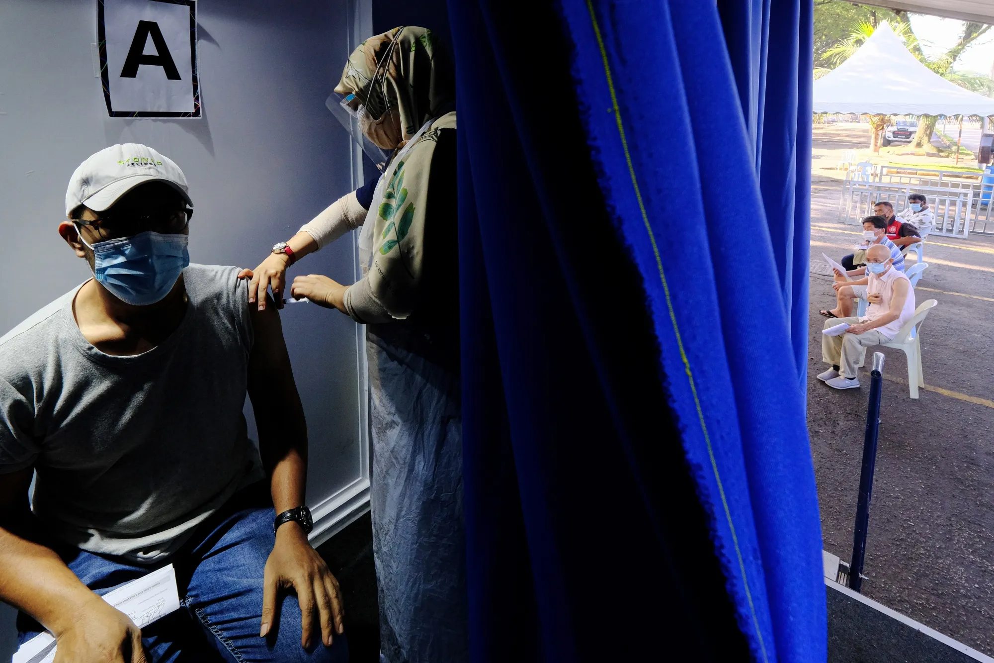 A worker receives a dose of the Sinovac Covid-19 vaccine in a mobile Covid-19 vaccine clinic on June 21.