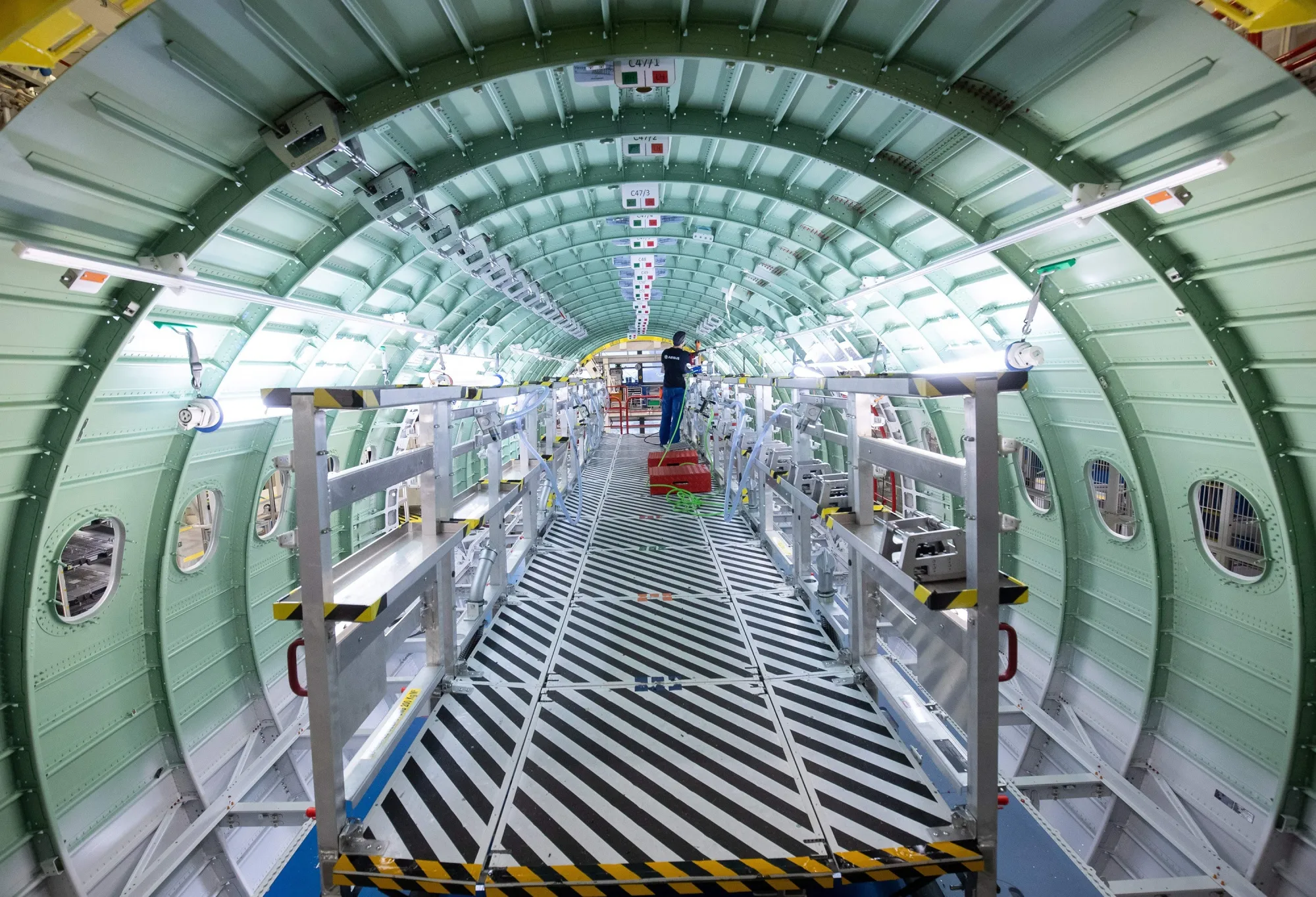 A technician of Airbus works in a fuselage segment of a plane belonging to the Airbus A320 family at the&nbsp;plant in Hamburg.