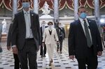 Nancy Pelosi wears a protective face covering while walking to the House Chamber in Washington, D.C., on April 23.