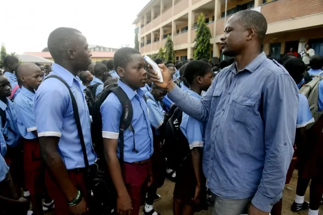 Pupils have their temperatures checked at a school in Lagos on Oct. 8, 2014
