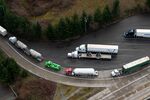 Tractor trailers entering Canada from the US at the Pacific Highway Border Crossing in Blaine, Washington, US, on Wednesday, March 5, 2025. Prime Minister Justin Trudeau is not open to lifting Canada’s full package of retaliatory tariffs if US President Donald Trump leaves any tariffs on Canada in place, according to a senior Canadian government official. Photographer: David Ryder/Bloomberg