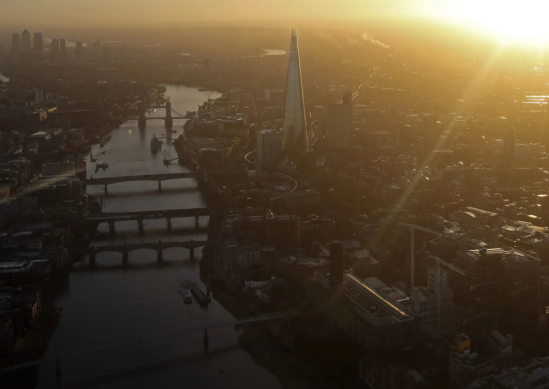 The early morning sun rises in London.
