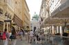 Pedestrians walk past retail stores and restaurants, in front of the Hofburg palace, in the Kohlmarkt area of Vienna, Austria, on Friday, July 3, 2015.
