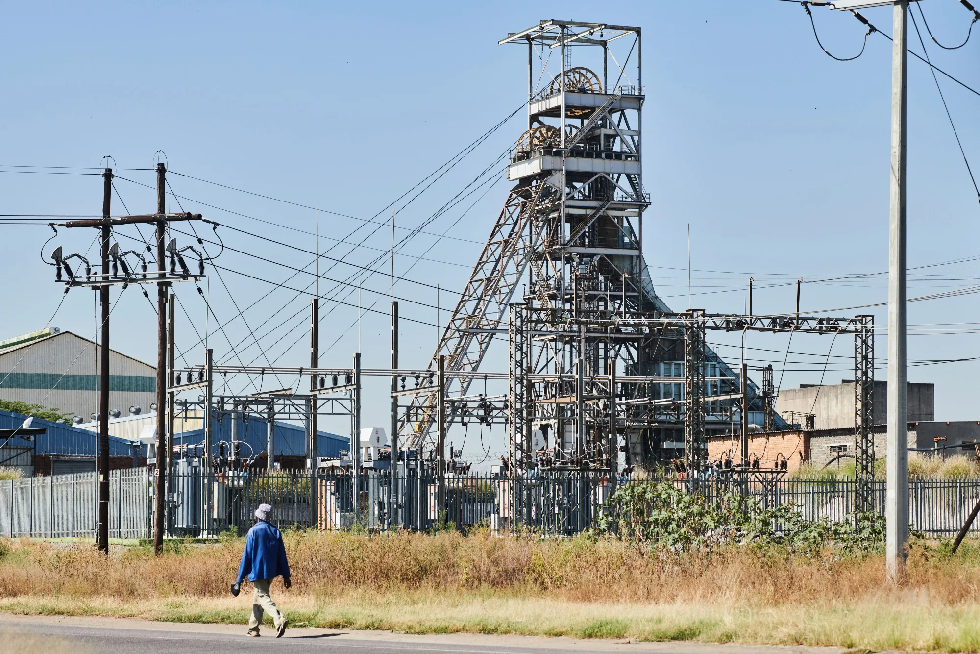 A worker walks along a road near the Impala Platinum Holdings Ltd., also known as Implats, shaft 1 mine in Rustenburg, South Africa.