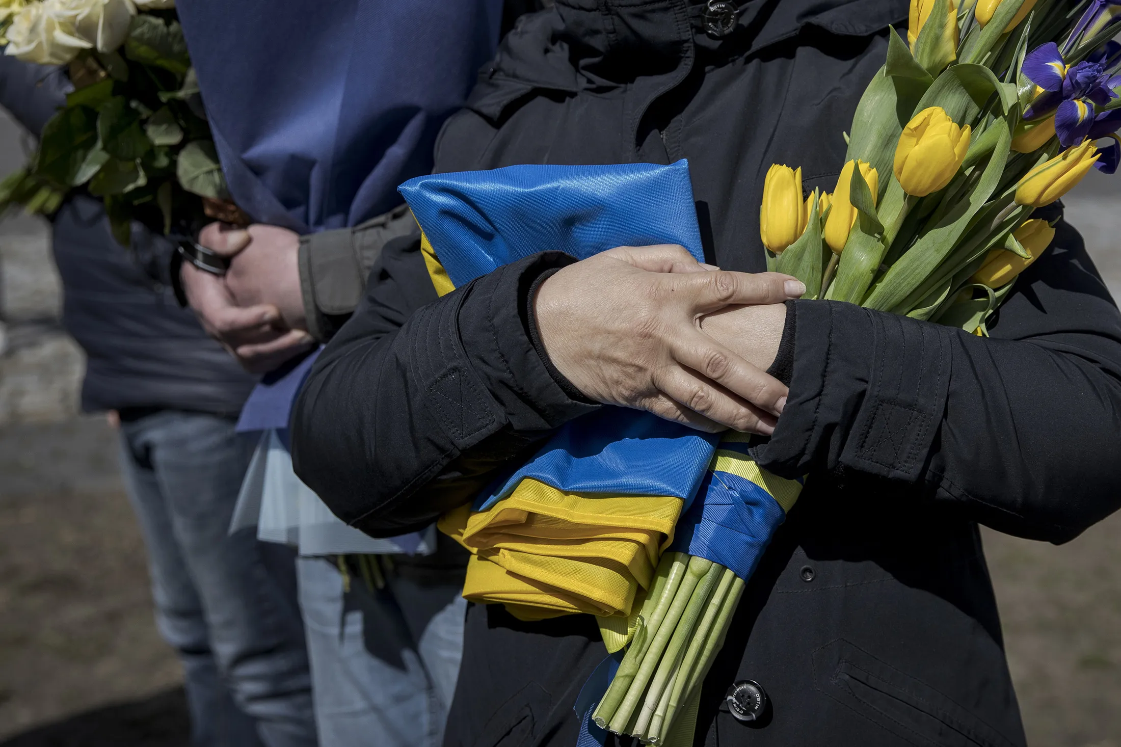 A mourner with flowers and a&nbsp;Ukrainian flag attends&nbsp;a funeral ceremony in Lviv, Ukraine on April 8.