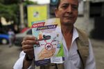A health worker shows a flyer used to explain how to prevent Dengue, Chikungunya, and Zika viruses in San Salvador, El Salvador.