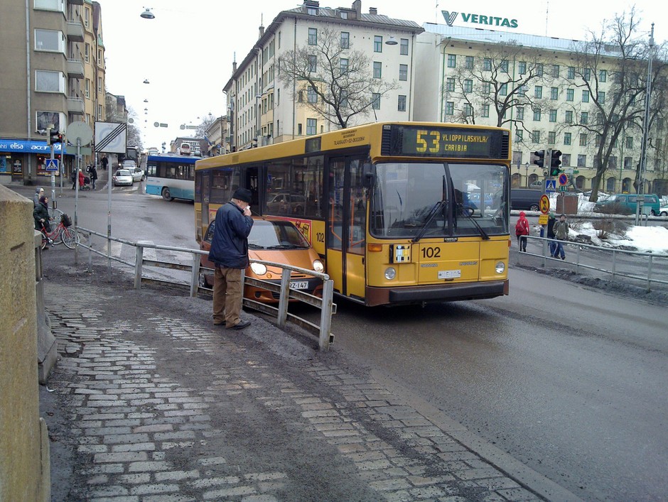 A car and a bus compete for space in Turku, Finland.