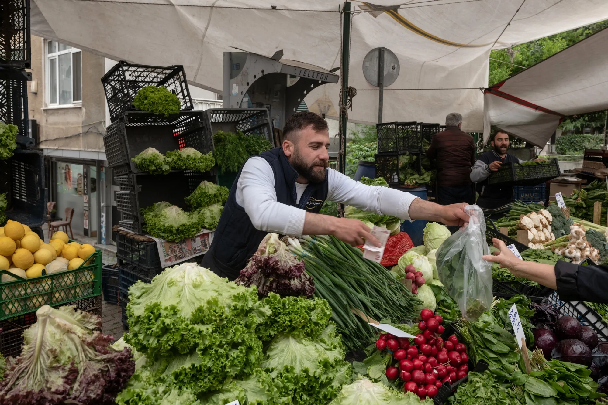 A vendor sells vegetables at the Friday Bazaar market in Istanbul.