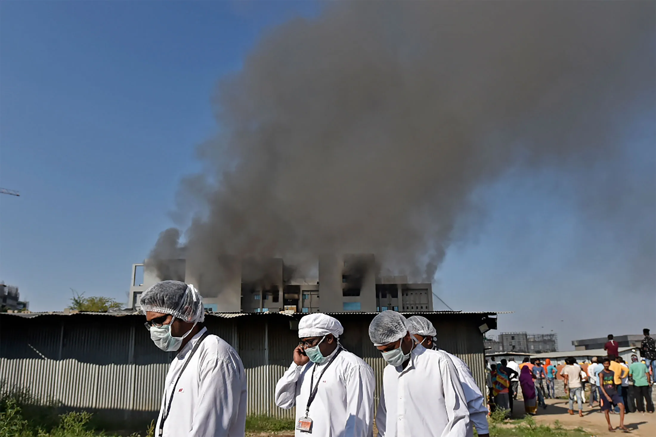Workers evacuated the building after a fire broke out at Serum Institute in Pune, India, on Jan. 21.