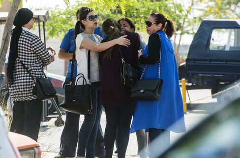 Families of passengers who were flying on board the EgyptAir plane that vanished from radar en route from Paris to Cairo react as they wait outside Cairo international airport, on May 19, 2016.