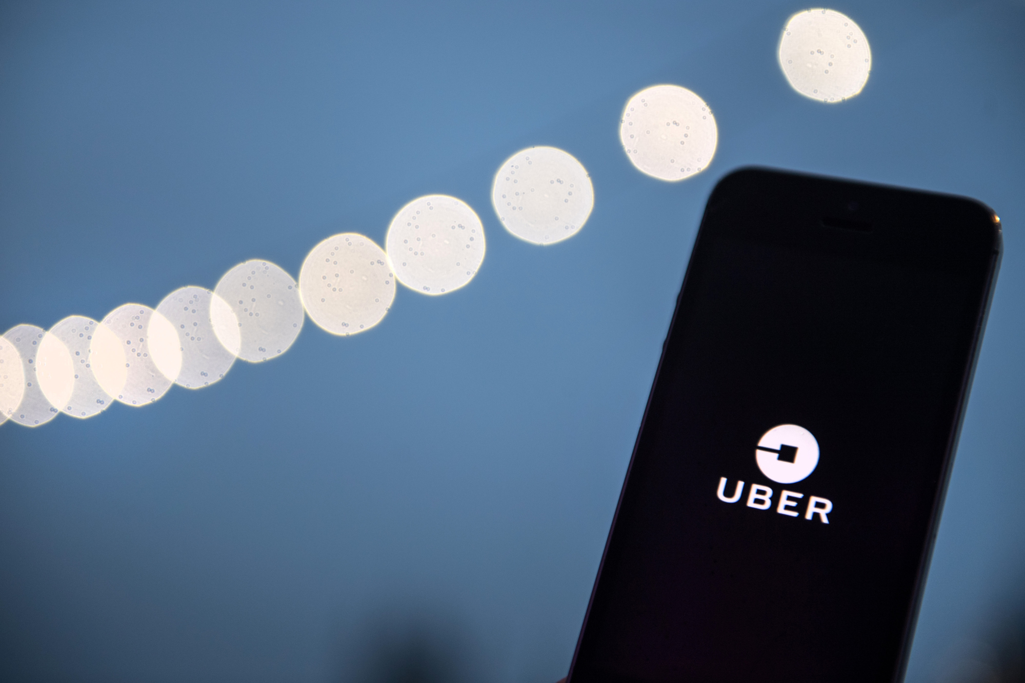 An Uber Technologies Inc. logo sits on a smartphone display in this arranged photograph in London, U.K.