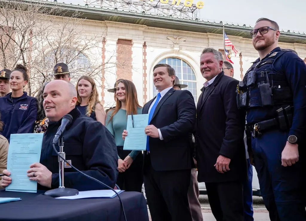 Utah Governor Spencer Cox (left) and Representative&nbsp;Tyler Clancy (center) at a bill signing ceremony in April.&nbsp;