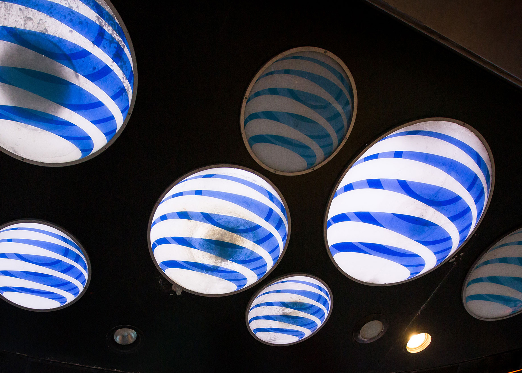 AT&T Inc. signage is displayed at the company\'s store in the Times Square area of New York, U.S., on Saturday, Oct. 22, 2016. According to a statement Saturday, AT&T agreed to buy Time Warner for $107.50 a share.