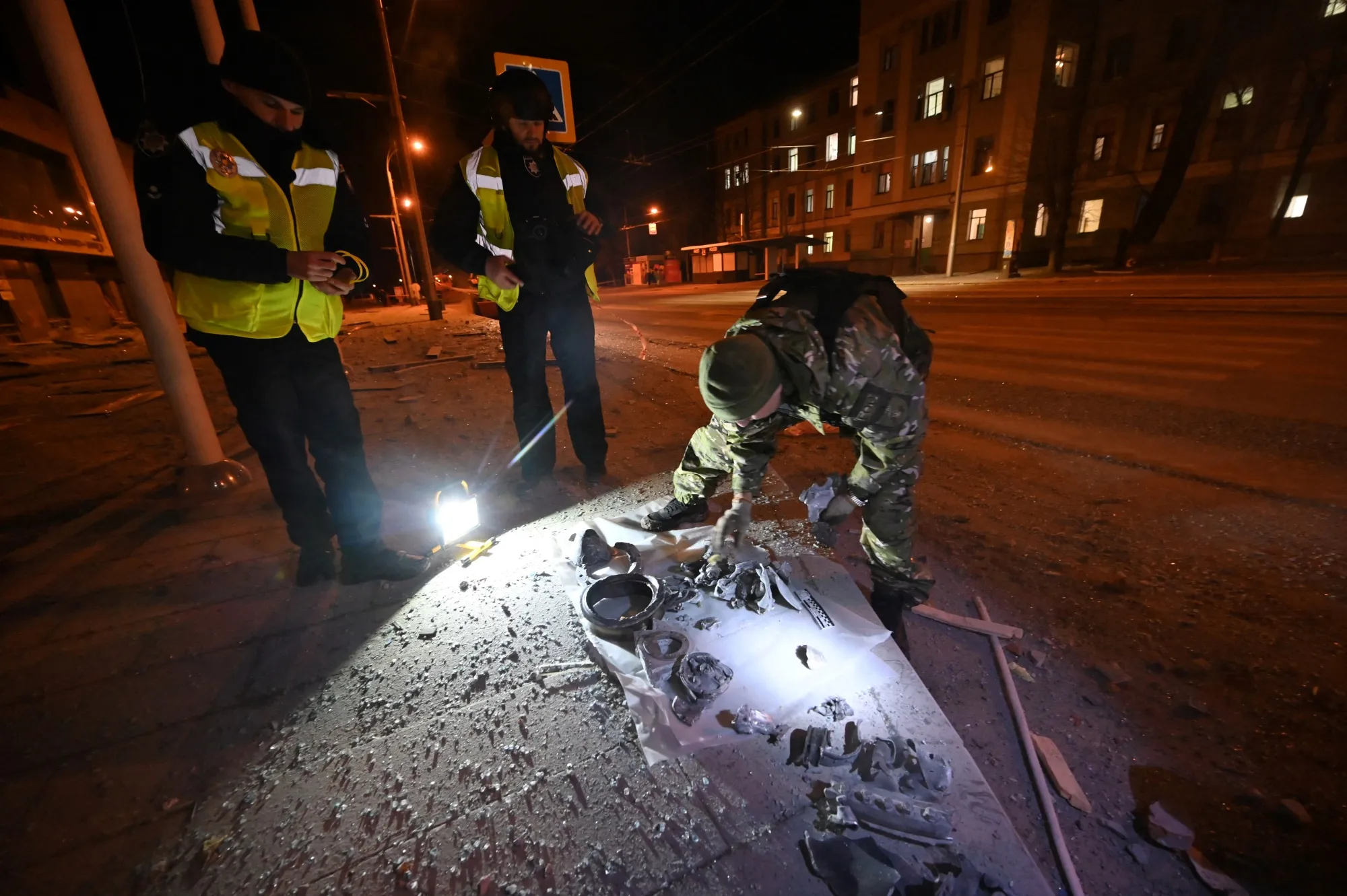 Forensics teams&nbsp;sift through remains from a missile strike&nbsp;in Kharkiv.