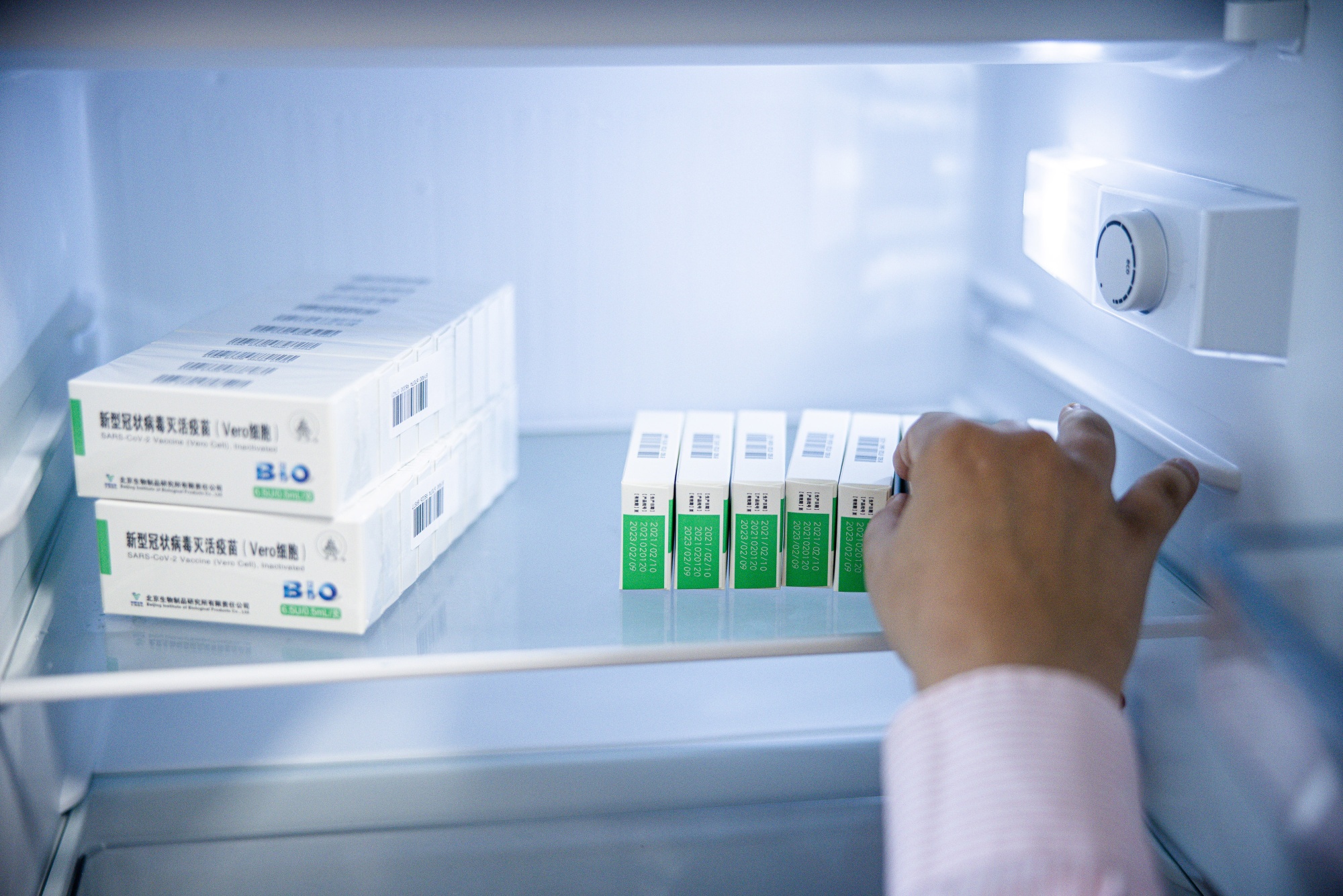 A medical worker removes a box of the Sinopharm Group Co. Covid-19 vaccine from a refrigerator at a clinic in Budapest, Hungary.
