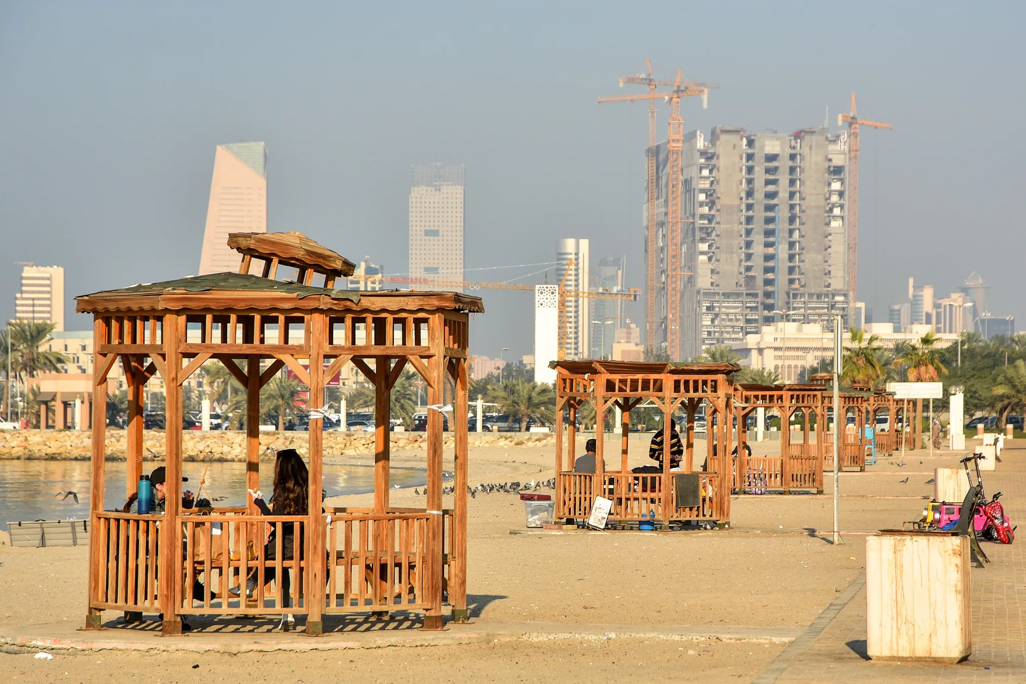 Residents shelter from the sun&nbsp;on Shuwaikh Beach&nbsp;in Kuwait City, Kuwait