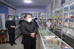 In this photo provided by the North Korean government, Kim Jong Un visits a pharmacy in Pyongyang on May 15.