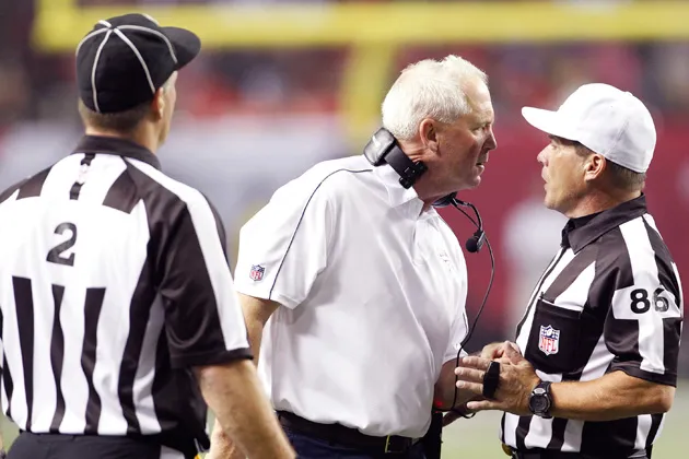 Denver Broncos head coach John Fox speaks with head referee Jimmy Buchanan and head linesman Kevin Akin during a game vs. the Atlanta Falcons at the Georgia Dome