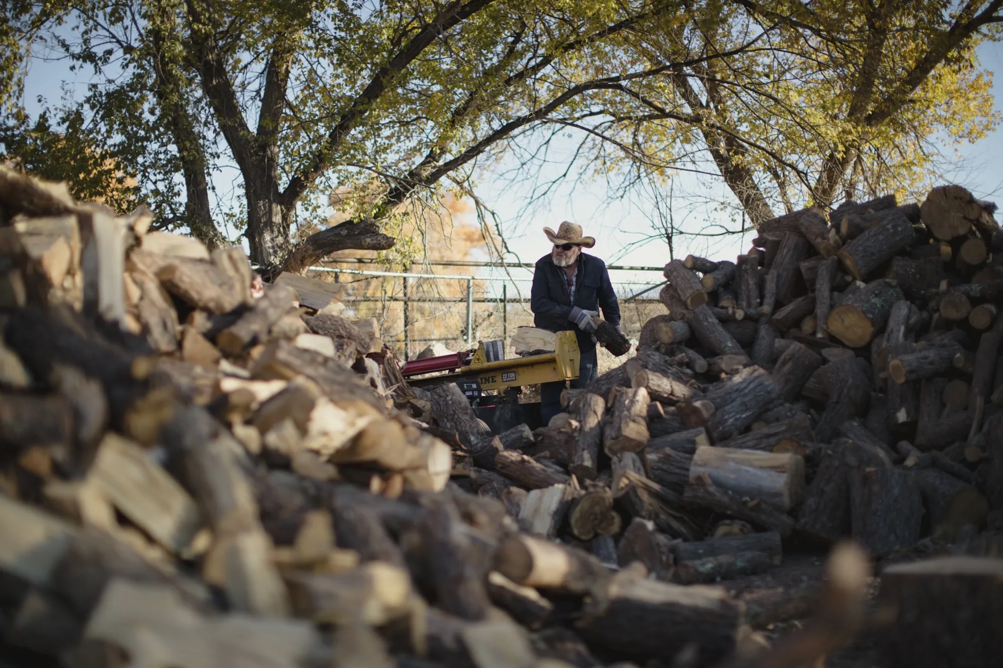 A worker splits wood at Zia Firewood in Albuquerque.