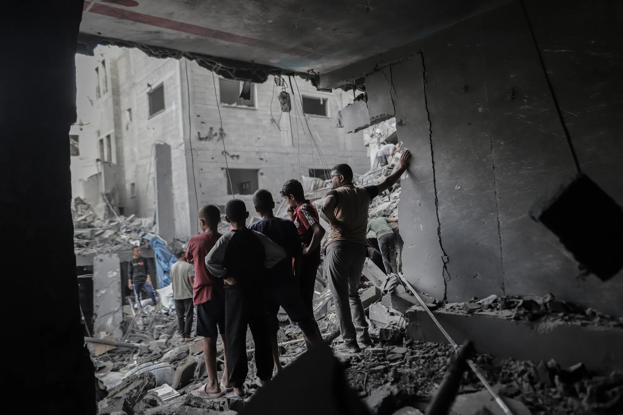 Palestinians look out from a damaged building at the Al-Shati refugee camp in Gaza City, in October.