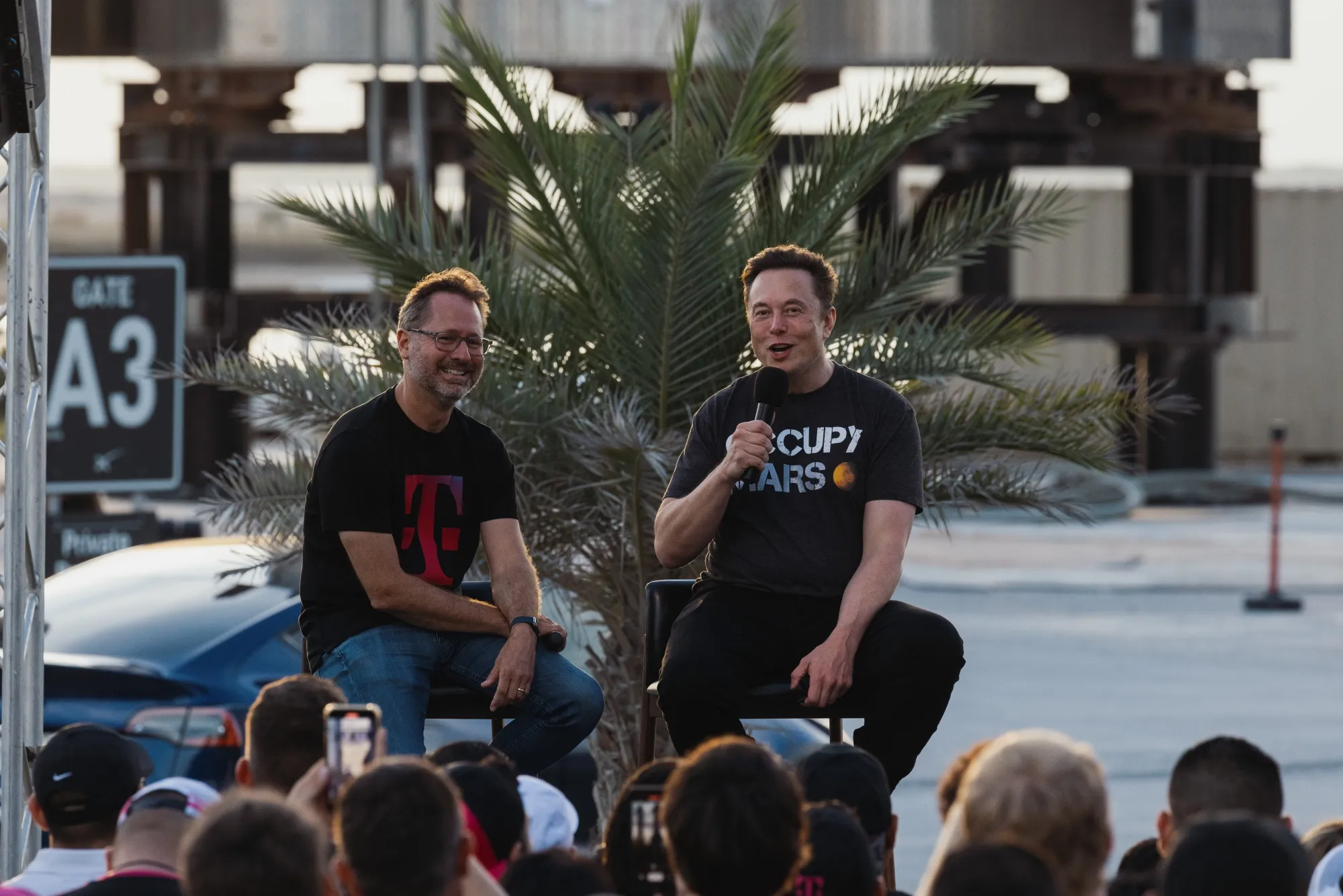 Elon Musk, right, with Mike Sievert, at the SpaceX Starbase facility in Boca Chica, Texas, on Aug. 25.