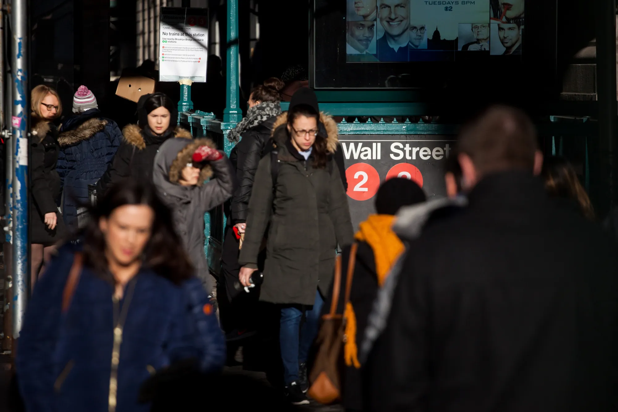 Pedestrians walk along Wall Street near the New York Stock Exchange (NYSE) in New York.