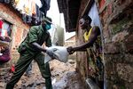 A military officer hands out food&nbsp;during the relief food distribution in Kampala, on April 4.&nbsp;