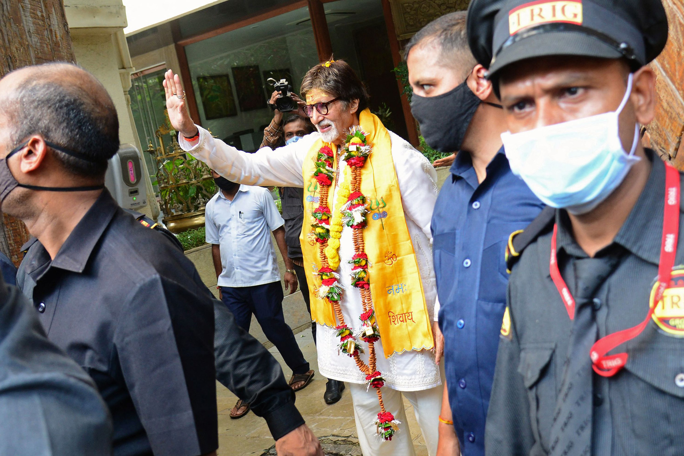 Amitabh Bachchan gestures to his fans gathered outside his residence to celebrate his birthday in Mumbai on Oct. 11.