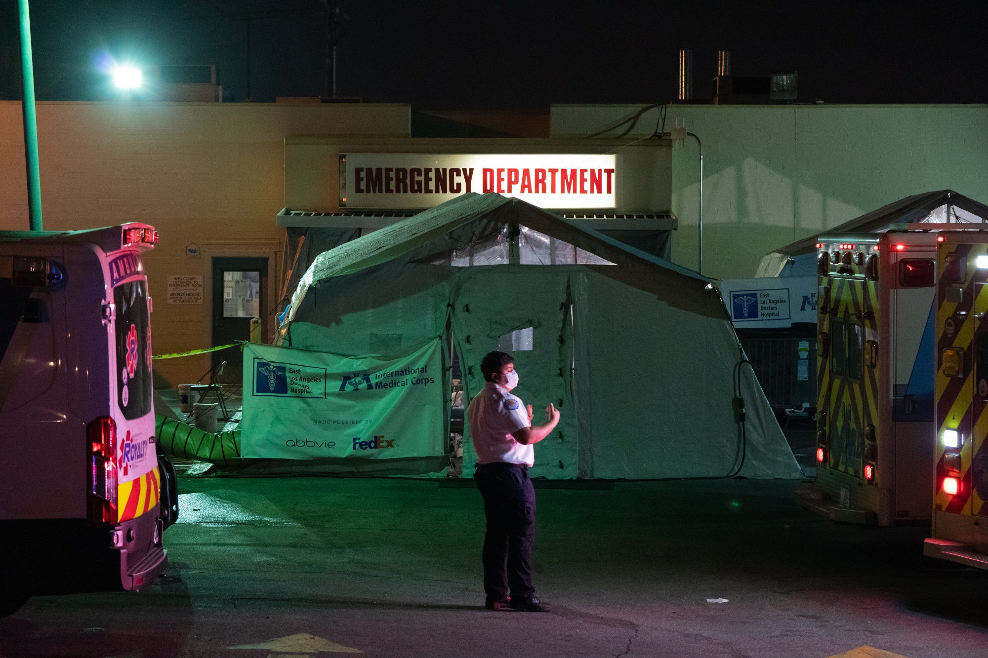 An EMT&nbsp;directs an ambulance outside the emergency room of the East Los Angeles Doctors Hospital in Los Angeles, Calif.,&nbsp;on&nbsp;Jan. 6.