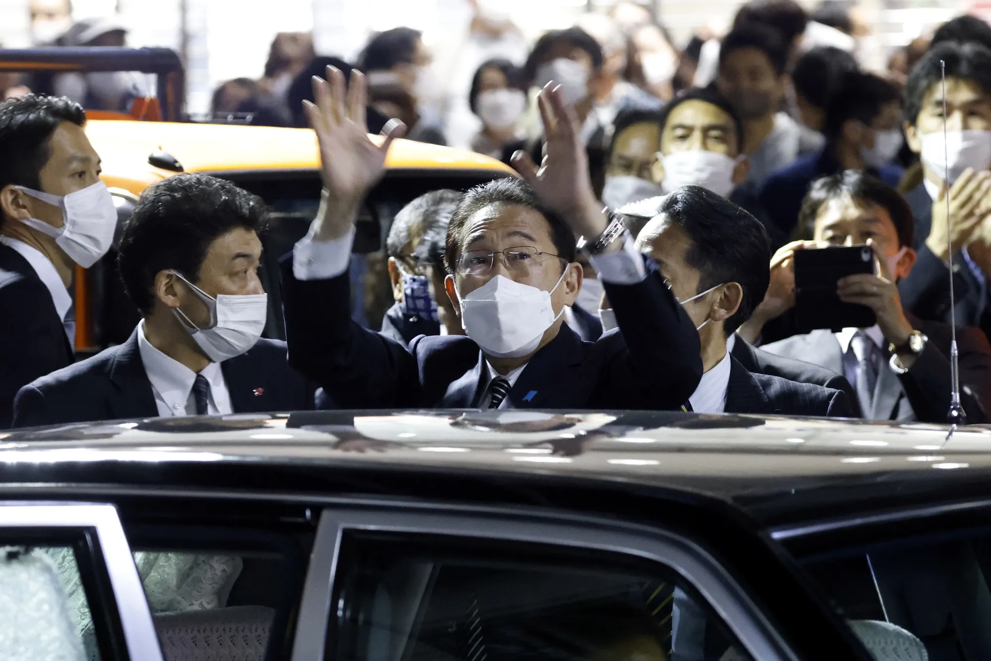 Fumio Kishida waves as he leaves an election campaign event in Tachikawa, Tokyo Metropolis, on Oct. 26.