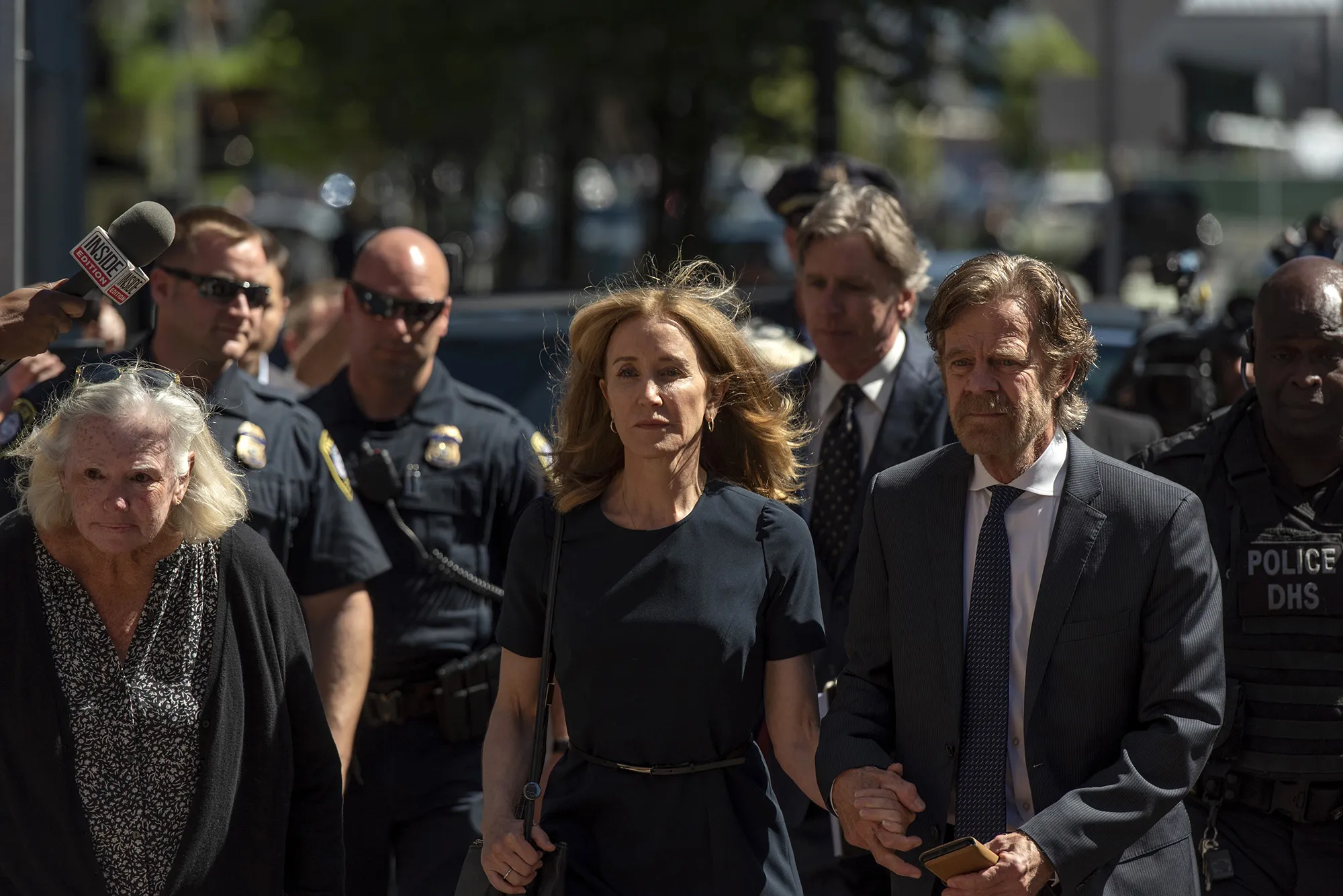 Felicity Huffman, center, arrives at federal court with her husband actor William H. Macy in Boston on Sept. 13.
