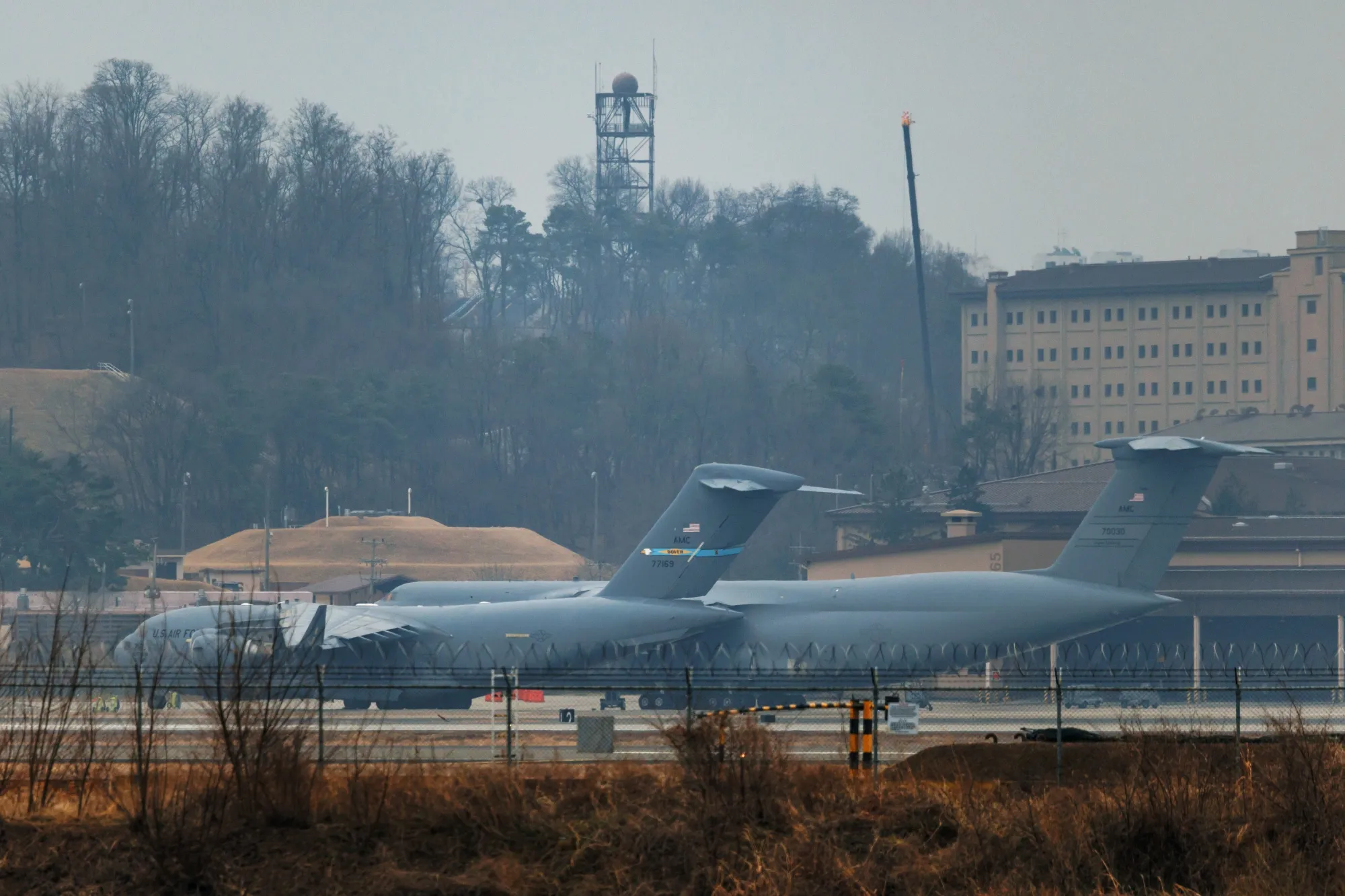 A C-17 US Air Force military transport aircraft, left, and a C-5 US Air Force military transport aircraft at Osan Air Base in Pyeongtaek, South Korea, on March 6.