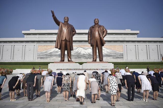 People are seen bowing before statues of North Korean leaders Kim Il Sung and Kim Jong Il in Pyongyang, in August 2024.