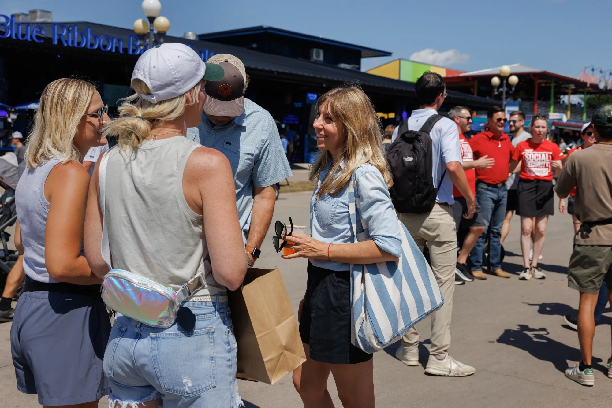 State Senator Sarah Trone Garriott, a Democrat from Iowa and US congressional candidate, center, greets attendees as Representative Zach Nunn, a Republican from Iowa, fourth right, takes a photo at the Iowa State Fair in Des Moines, Iowa,&nbsp;on&nbsp;Aug. 13.