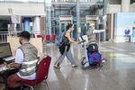 A traveler pushes a cart upon arrival at the Ngurah Rai International Airport in Bali on March 7.