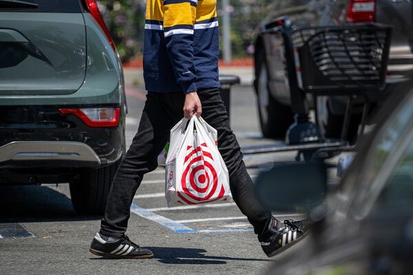 A shopper carries a shopping bag outside a Target store in Emeryville, California, US. 
