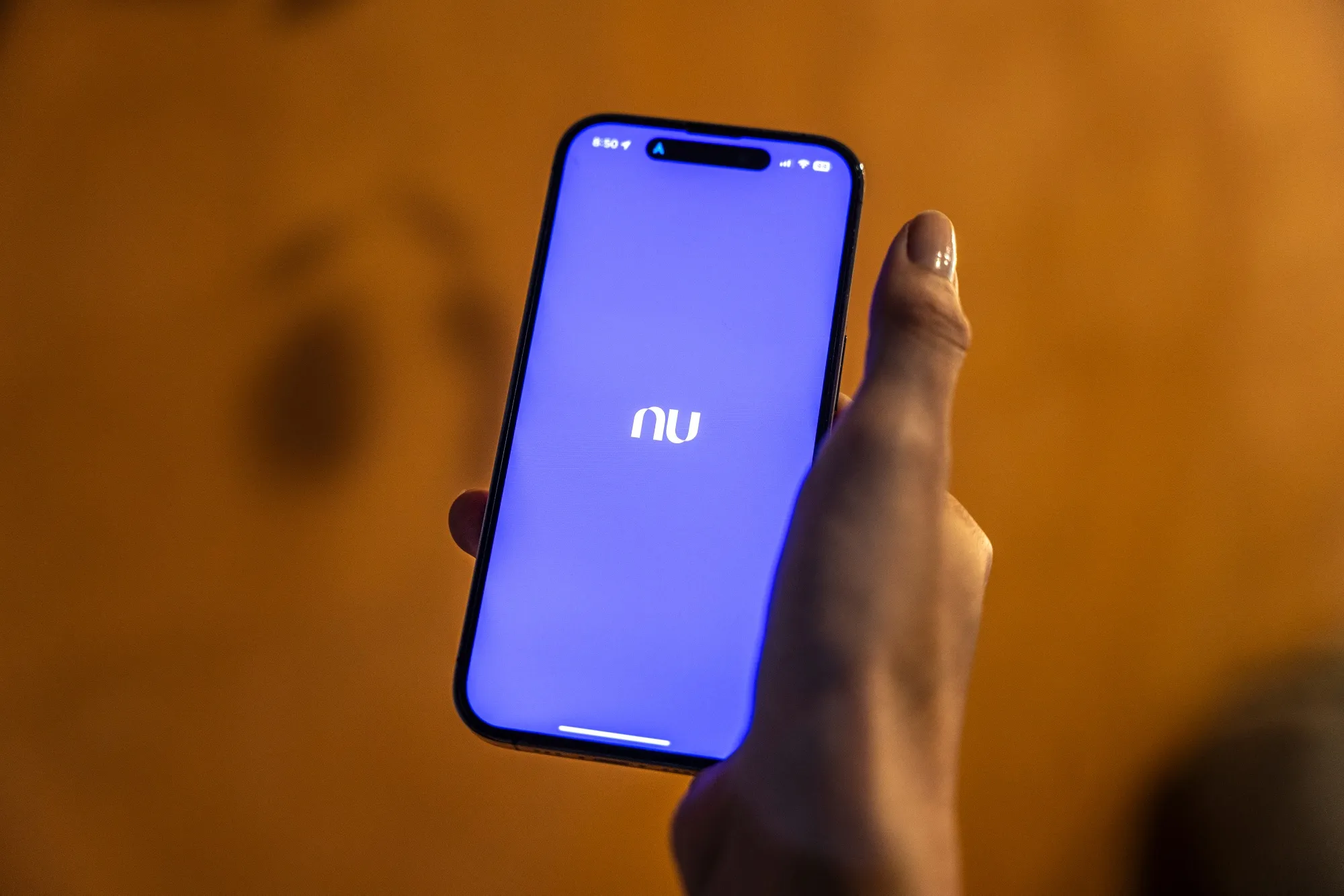 The Nubank logo on a smartphone.