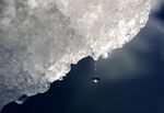 A drop of water falls off an iceberg melting in the Nuup Kangerlua Fjord near Nuuk in southwestern Greenland, Tuesday, Aug. 1, 2017. According to a report by the U.S. National Oceanic and Atmospheric Administration released on Tuesday, Dec. 14, 2021, the Arctic continues to deteriorate from global warming, not setting as many records this year as in the past, but still changing so rapidly that federal scientists call it alarming. (AP Photo/David Goldman)