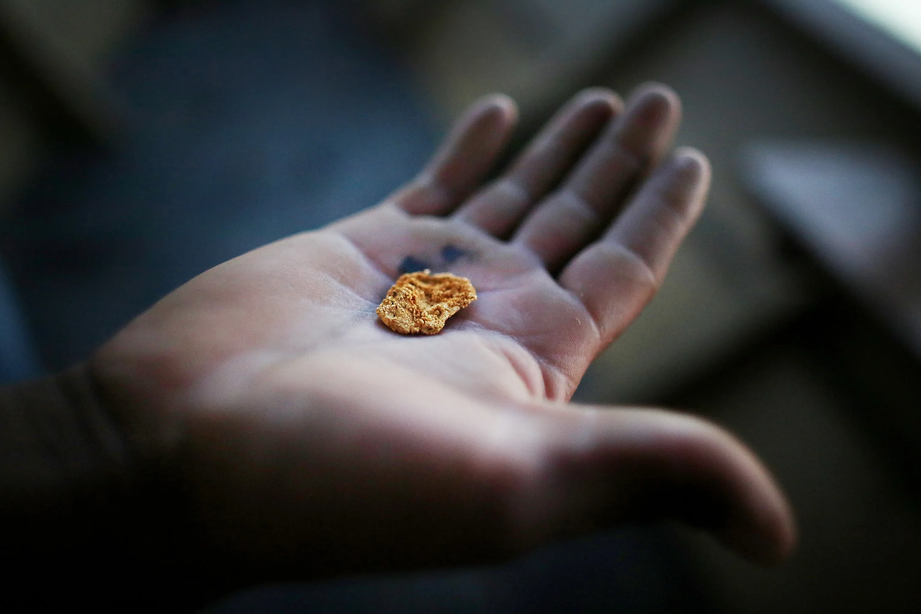 A gold miner displays a piece of gold along the Madre de Dios River near Puerto Maldonado, Peru.