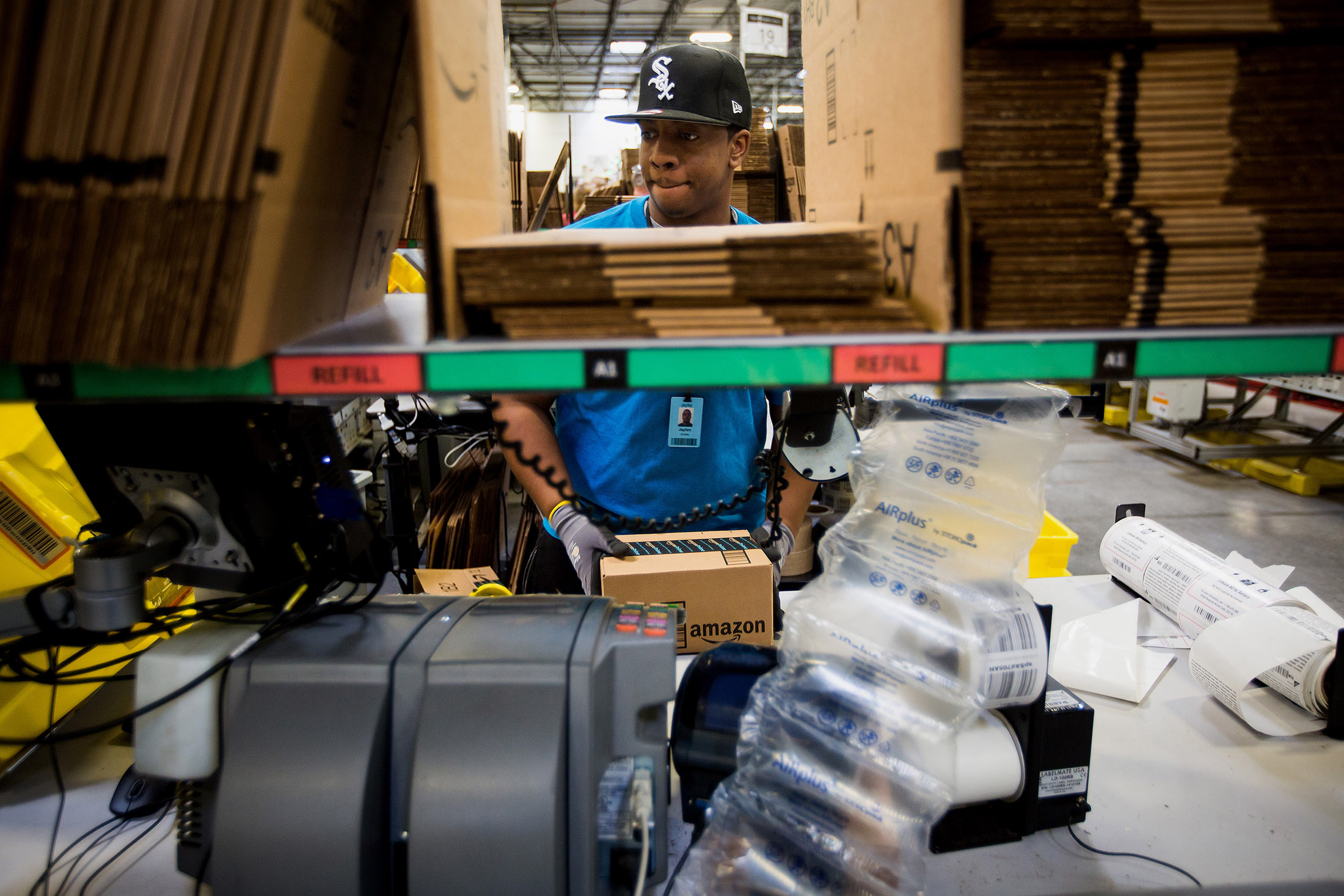 An employee packs a box at the Amazon.com Inc. fulfillment center in Robbinsville, New Jersey, on Nov. 30.
