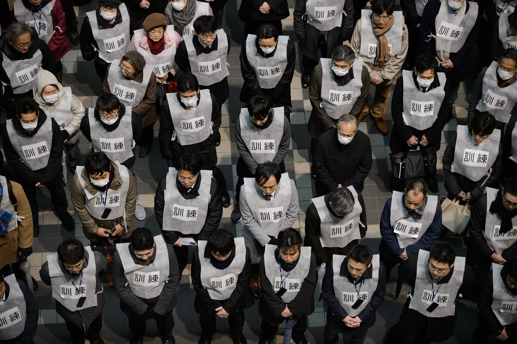 Participants of a missile-attack drill gather after the drill in Tokyo, Japan, on Jan. 22, 2018. The government planned Monday’s exercise to raise awareness about taking action should a ballistic device be detected heading for the densely populated Japanese capital.