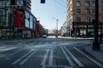 A vehicle waits at a traffic signal light on a near empty road in Seattle, Washington, on March 18