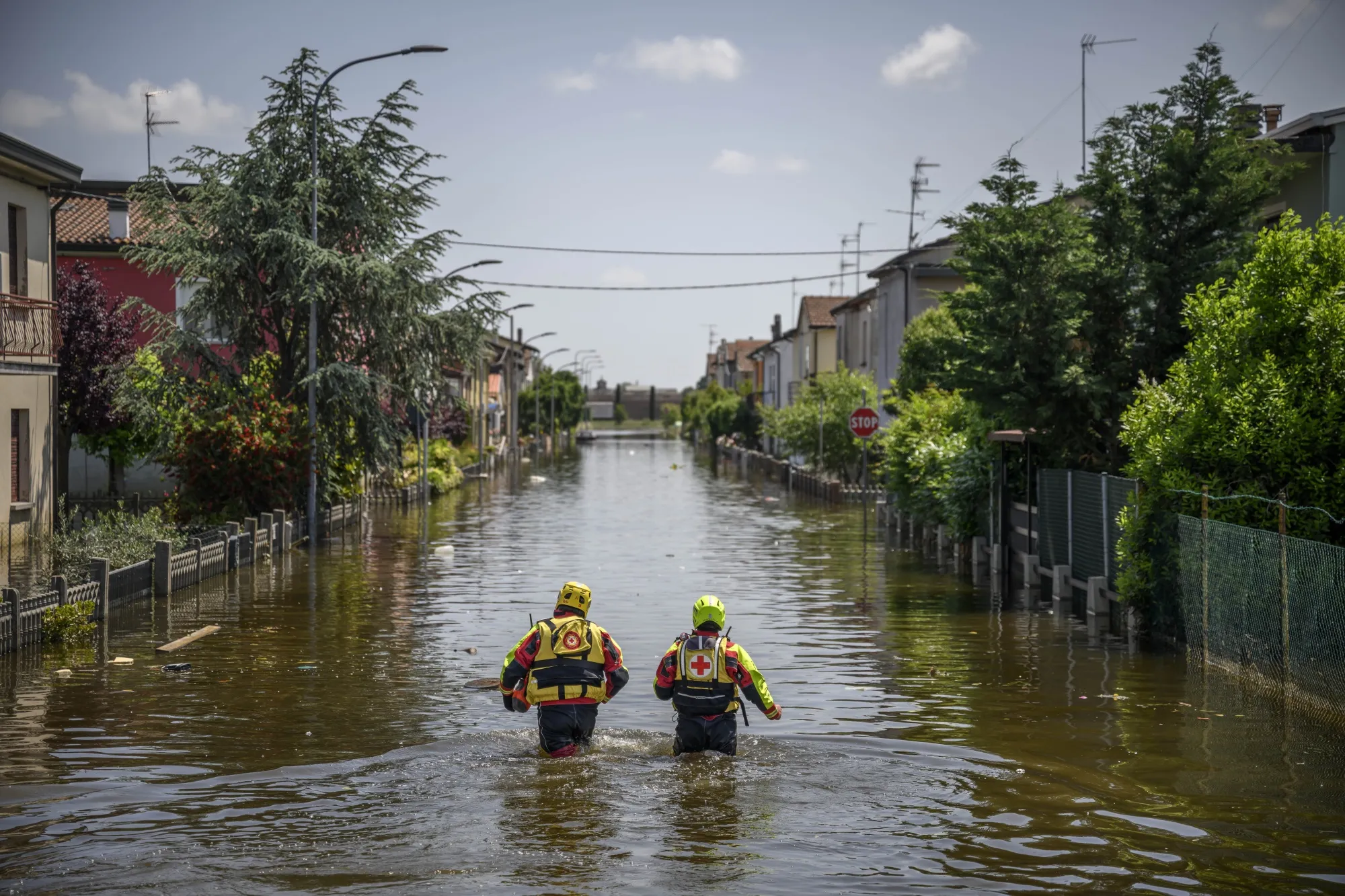 Members of the Italian Red Cross and firefighter&nbsp;rescuers seek and help residents&nbsp;on May 25 in Conselice, Italy.